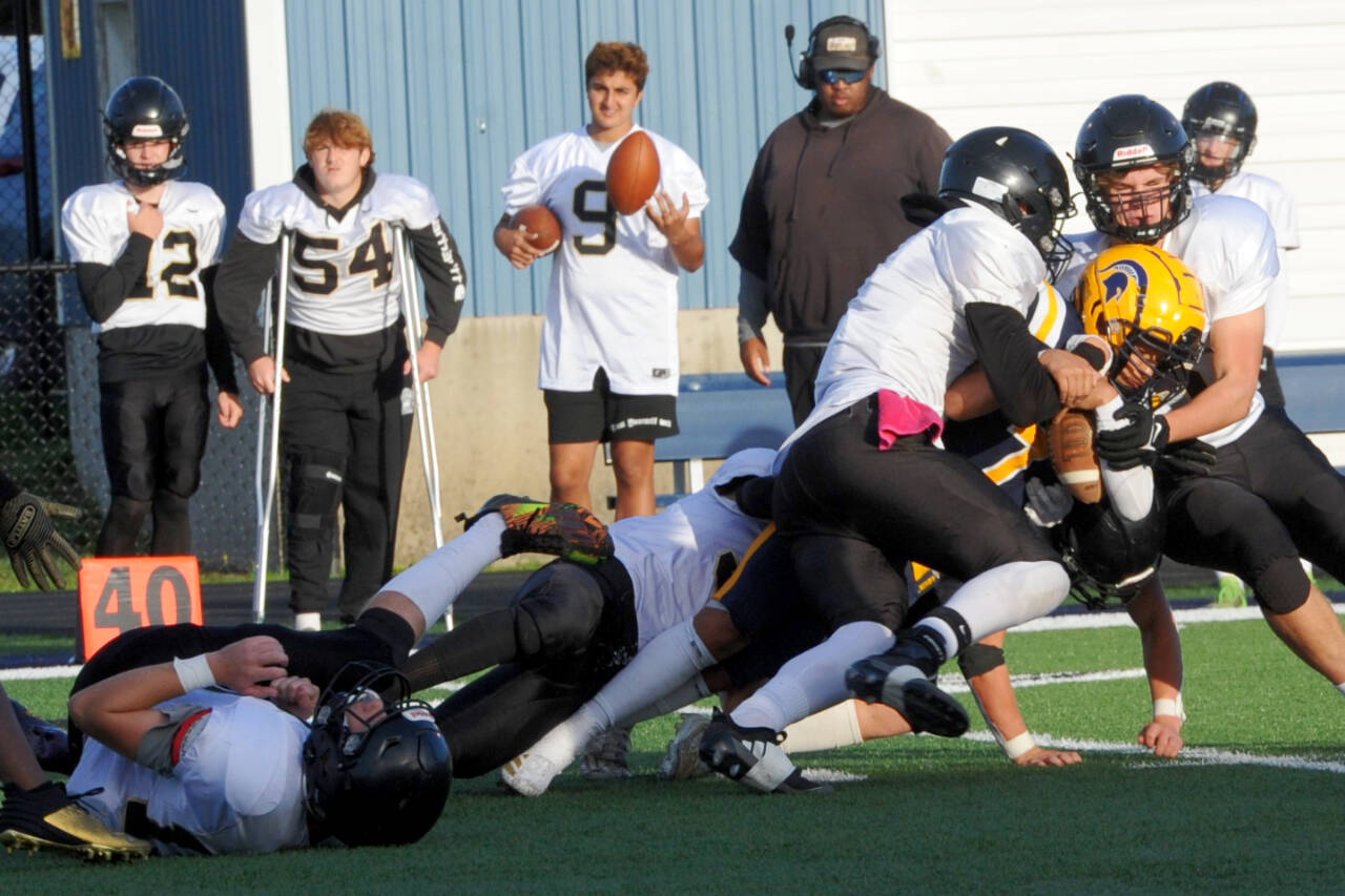 Forks' Estevan Ramos is tackled by Meridian defenders in a game Friday in Forks. The Spartans lost 54-7 in a nonleague game against the 1A powerhouse. (Lonnie Archibald/for Peninsula Daily News)