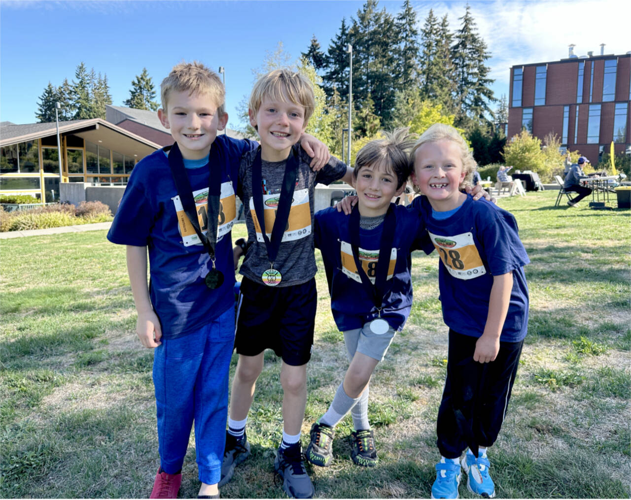 The top racers in the first- through second-grade division at the Little Hurt celebrate their medals Sunday. From left are Kelton Fogerty, Henry Herschmiller, Isaac Simoneau and Magnus Jensen. Herschmiller won his age group. (Photo by Courtney Nestler)