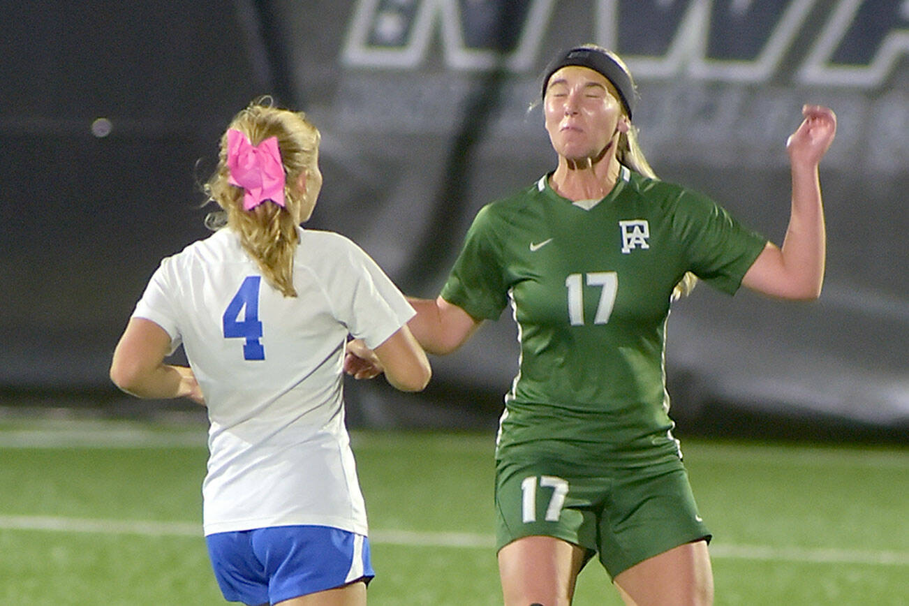 KEITH THORPE/PENINSULA DAILY NEWS
Port Angeles' Ava-Anne Sheahan, right, takes the header as Bremerton's Melanie Uhrich closes in on Tuesday night in Port Angeles.