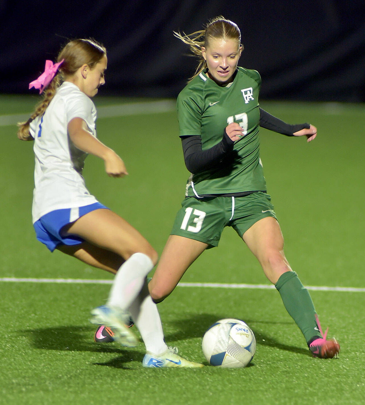 KEITH THORPE/PENINSULA DAILY NEWS Port Angeles’ Brook Pierce, right, fends off Bremerton’s Harlow Moffet during Tuesday’s match at Peninsula College.