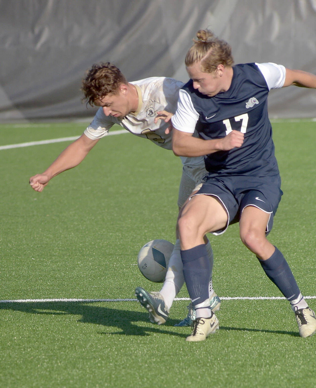 KEITH THORPE/PENINSULA DAILY NEWS Peninsula’s Konrad Muller, left battles for the ball with Bellevue’s Kel Isar on Wednesday in Port Angeles.