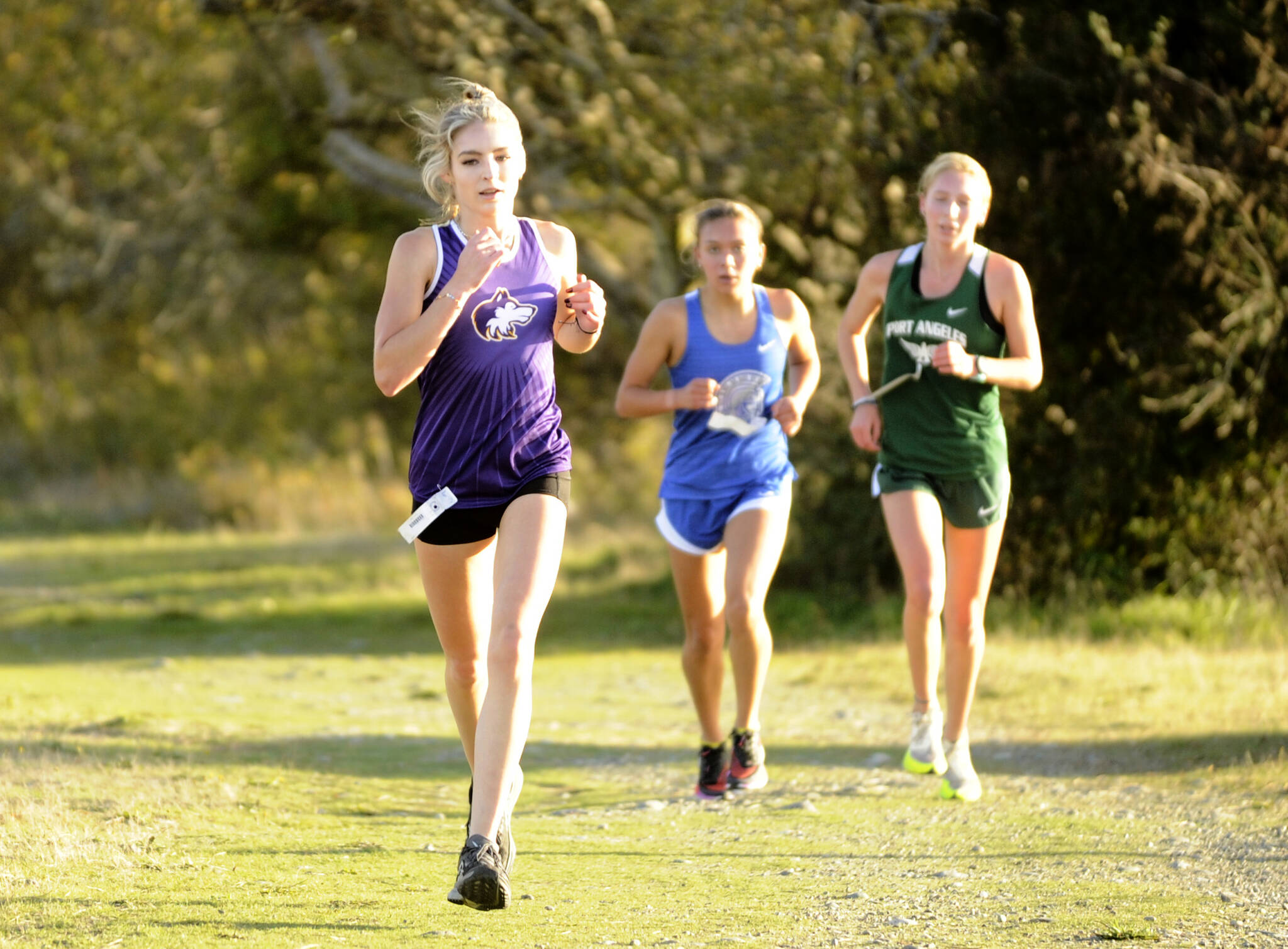 Michael Dashiell/Olympic Peninsula News Group
Sequim’s Dawn Hulstedt runs ahead of Olympic’s Brynn Fulton and Port Angeles’ Leia Larson during the Olympic League cross country meet at Voice of America at the Dungeness Recreation Area on Wednesday.