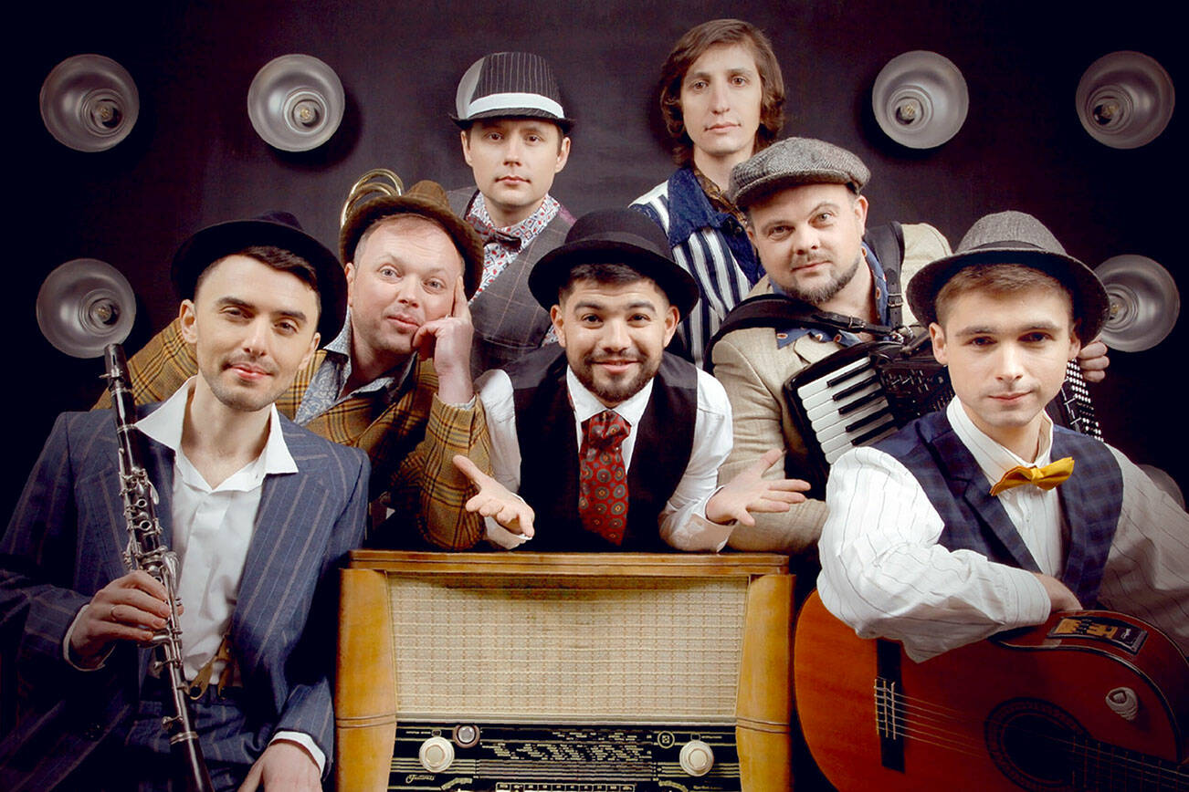 Bagrat Tsurkan (vocals) in center. Clockwise from the bottom left, Volodymyr Gitin (clarinet), Andrei Okhramovich (trumpet), Yaroslav Besh (trombone), Sergei Poltorak (percussion), Oleg Vasianovich (accordion) and Viktor Kirilov (acoustic guitar).