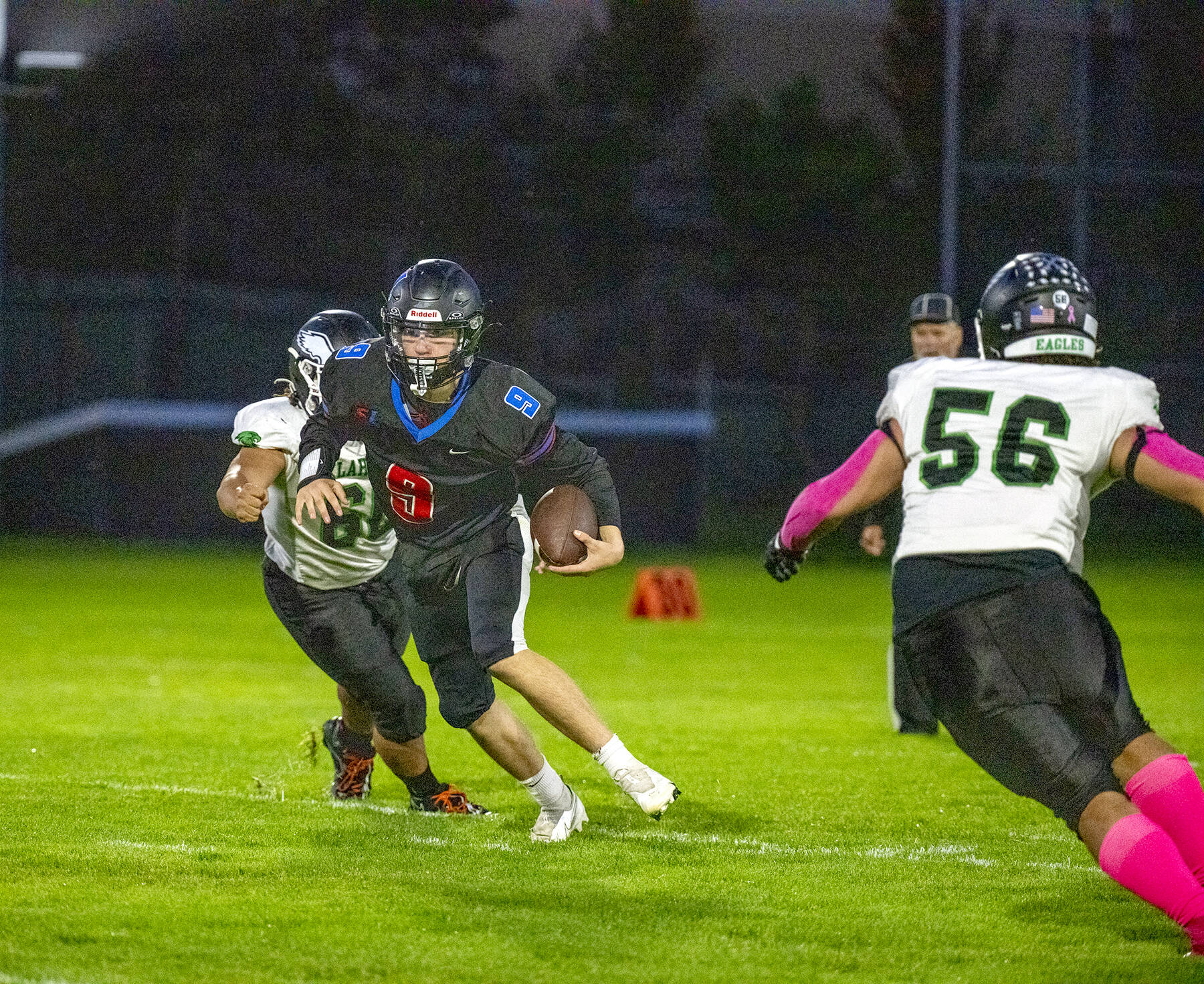 Steve Mullensky/for Peninsula Daily News

Rivals' quarterback Silas Morford spots a hole and runs for yardage in a Nisqually League game played against the Klahowya Eagles on Friday night at Memorial Field in Port Townsend.