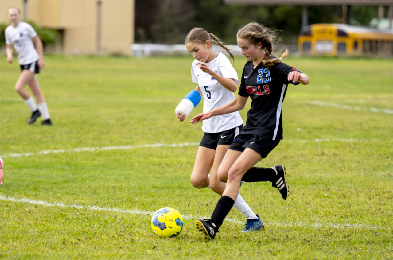 East Jefferson midfielder Olivia McClemans beats Bush’s Kate Van Nimwegen to the ball in a nonleague game Saturday in Chimacum. (Steve Mullensky/for Peninsula Daily News)