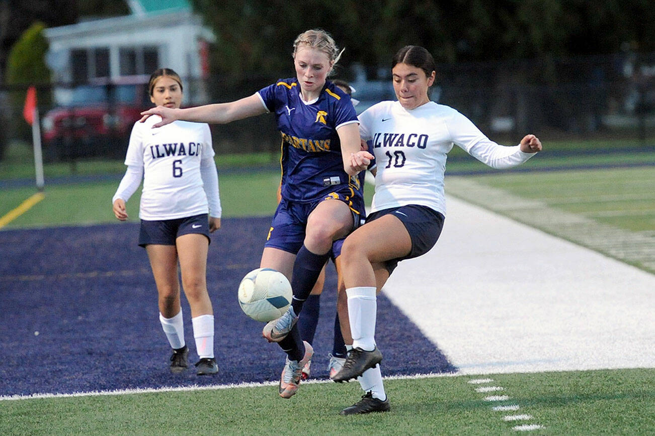 Spartan Miley Blanton (center) controls the ball between Ilwaco players Sharon Merino Orozco (6) and Jacquelyn Hernandez (10).  Forks defeated the Fisherman 4 to 0 at Spartan Stadium.  Photo by Lonnie Archibald.