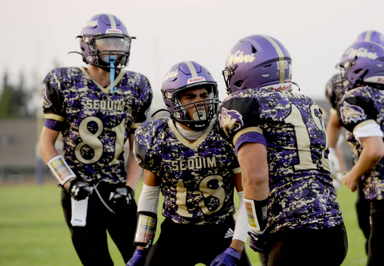 Sequim Wolves, from left, Ethan Melnick, Malachi Hampton and Liam Wiker take on North Kitsap in Poulsbo in a rare Thursday game. (Michael Dashiell/Olympic Peninsula News Group)