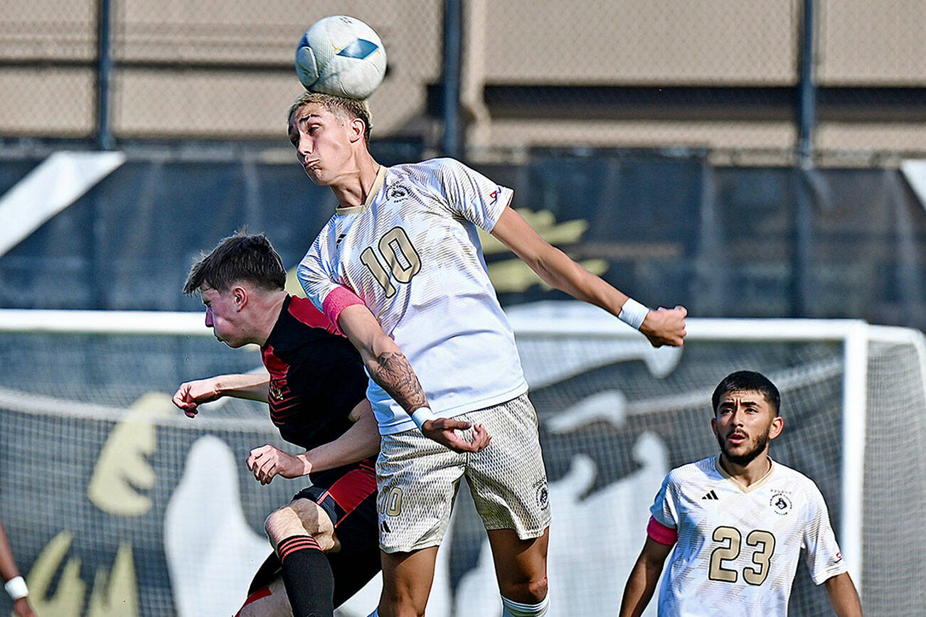 Jay Cline/for Peninsula College Athletics
Peninsula's Nil Grau leaps for a header in front of a Skagit Valley opponent as teammate Edwin Diaz looks on during the Pirates' 2-1 victory over the Cardinals on Wednesday at Wally Sigmar Field.