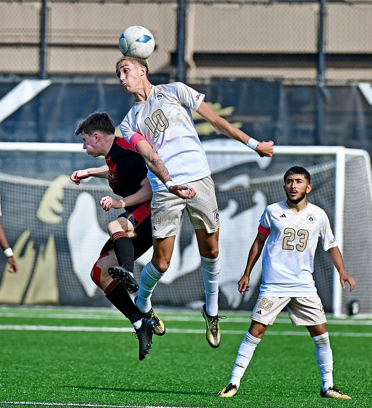 Jay Cline/for Peninsula College Athletics Peninsula’s Nil Grau leaps for a header in front of a Skagit Valley opponent as teammate Edwin Diaz looks on during the Pirates’ 2-1 victory over the Cardinals on Wednesday at Wally Sigmar Field.