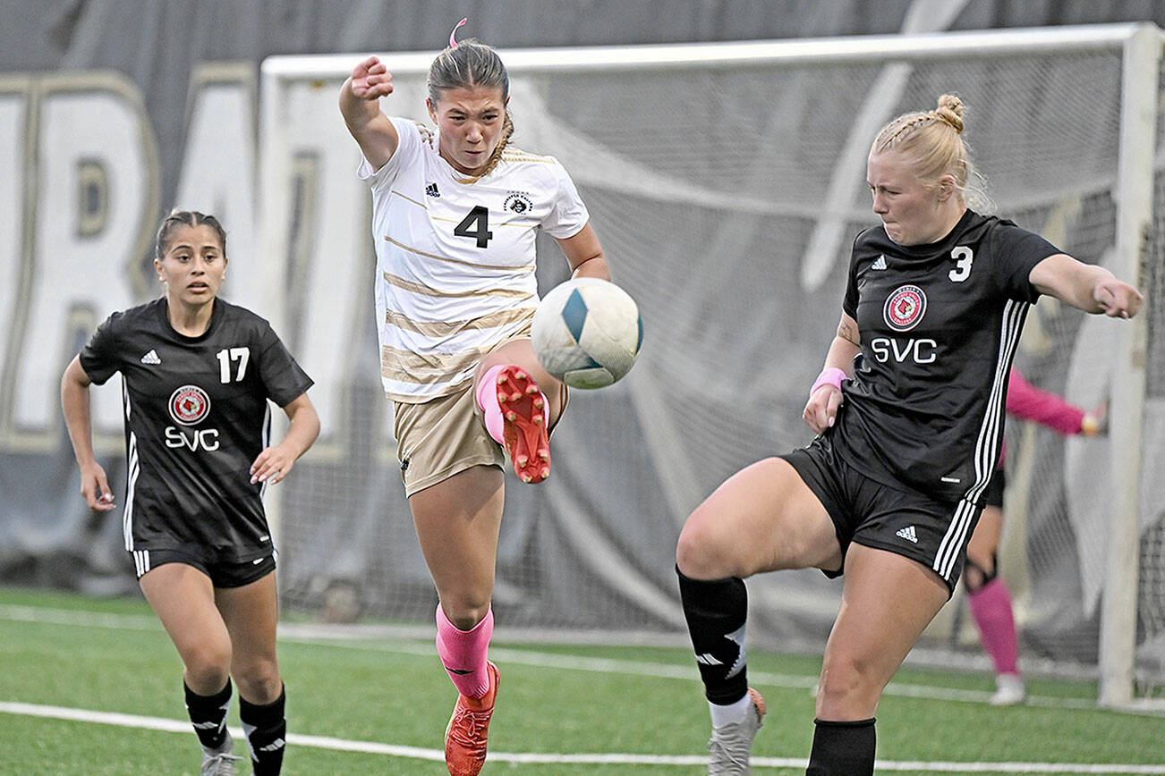 Jay Cline/for Peninsula College Athletics
Peninsula's Shawna Larson, center, concentrates on the ball in front of Skagit Valley's Paige Mason, right, a 2024 Port Angeles High School graduate, and Stephanie Ortiz during the Pirates' 4-1 win Wednesday at Wally Sigmar Field.