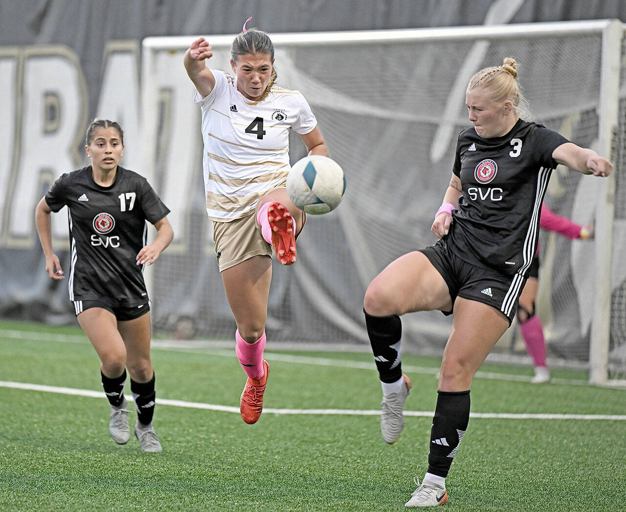 Jay Cline/for Peninsula College Athletics Peninsula’s Shawna Larson, center, concentrates on the ball in front of Skagit Valley’s Paige Mason, right, a 2024 Port Angeles High School graduate, and Stephanie Ortiz during the Pirates’ 4-1 win Wednesday at Wally Sigmar Field.