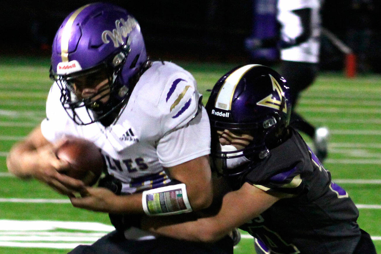 Elisha Meyer/Kitsap News Group 
Sequim’s Liam Wiker is tackled by North Kitsap’s Townsyn Walsh in the first half of the Wolves’ 30-7 Olympic League loss in Poulsbo on Thursday.