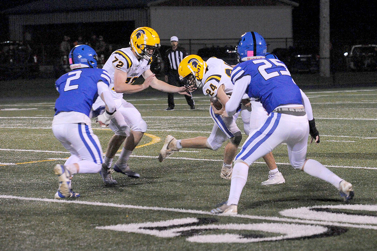 Spartan freshman running back Kingston Steffen (24) picks up yardage against Adna during the first quarter Friday at Spartan Stadium. After Forks led 14-13 at the half, Adna came back in the second half to win 43-14.
(Lonnie Archibald/for Peninsula Daily News)