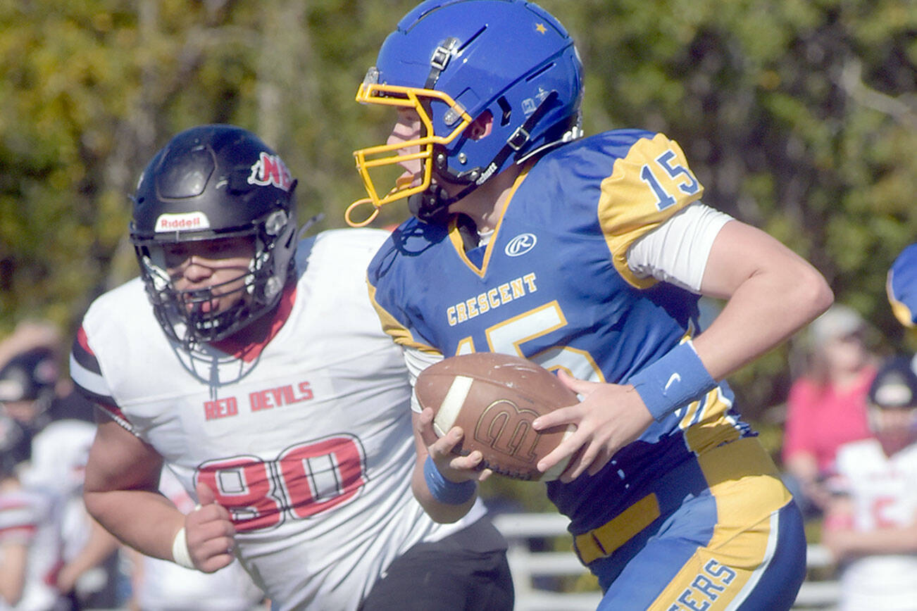 KEITH THORPE/PENINSULA DAILY NEWS
Crescent's Henry Bourm, front,carries the ball as Neah Bay's Carlos Carrick-Aguirre gives chase on Saturday afternoon in Joyce.