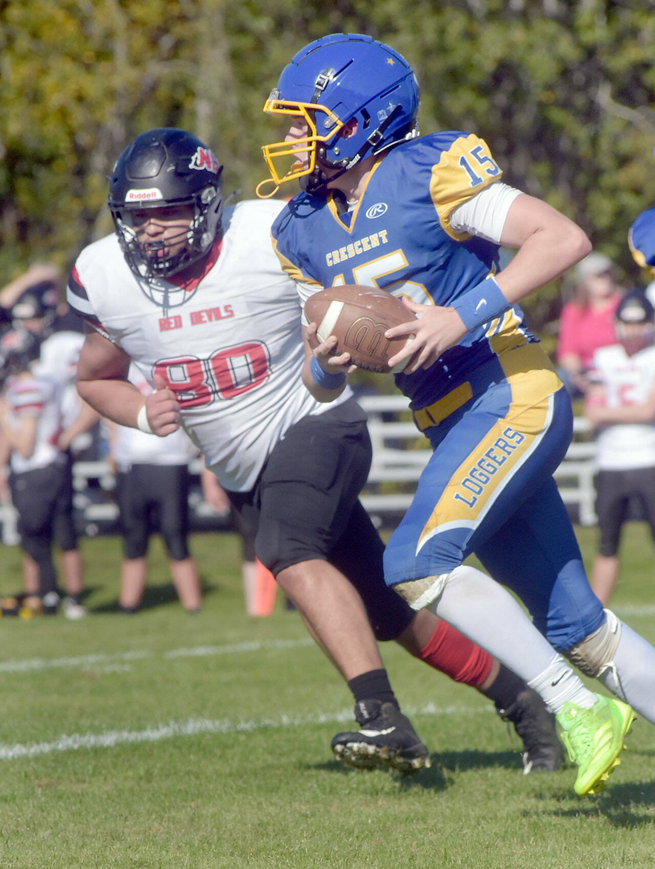 KEITH THORPE/PENINSULA DAILY NEWS Crescent’s Henry Bourm, front,carries the ball as Neah Bay’s Carlos Carrick-Aguirre gives chase on Saturday afternoon in Joyce.