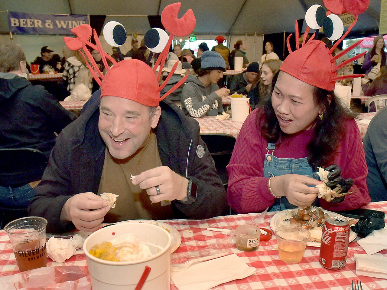 David and Tor Patsiga of University Place enjoy a crab dinner Saturday during the annual Dungeness Crab Festival in downtown Port Angeles. The three-day event featured a variety of seafood and other culinary treets, as well as crafts, music and other activities. (KEITH THORPE/PENINSULA DAILY NEWS)