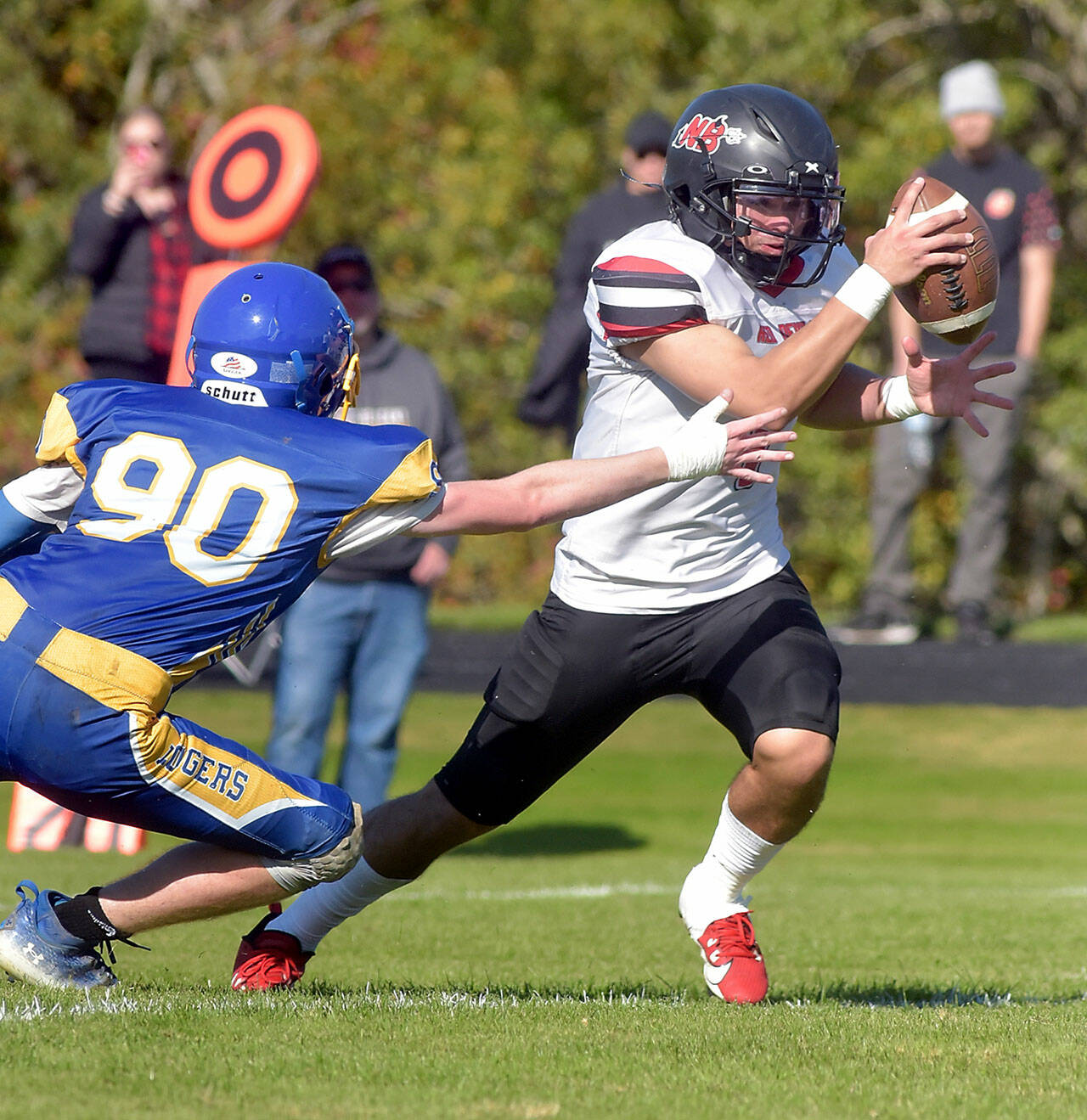 KEITH THORPE/PENINSULA DAILY NEWS Neah Bay runningback Jodell Wimberly evades the tackle of Crescent’s Logan Simons during Saturday’s game in Joyce.