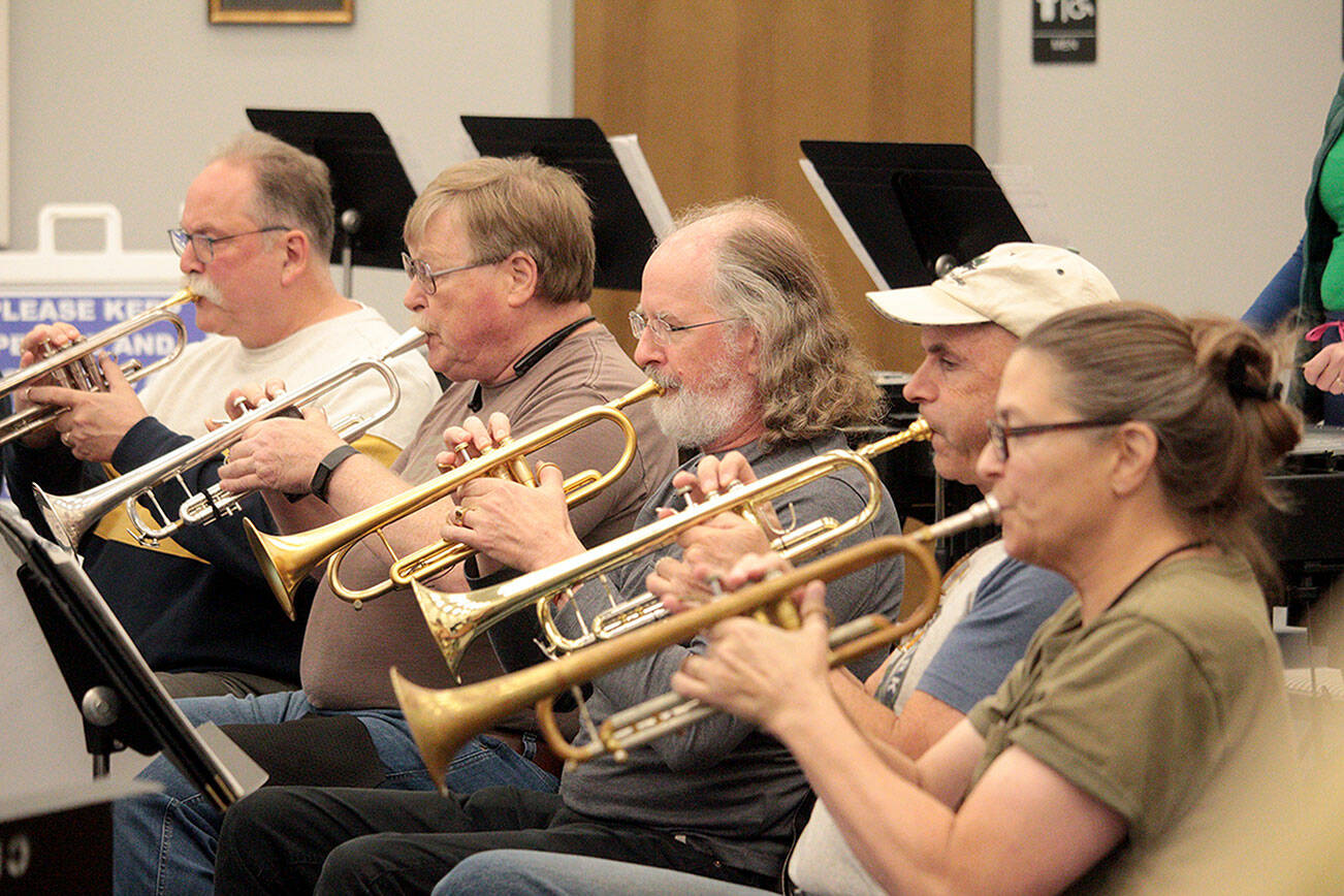 From left, Jim Bradbury, Terry Fogerson, Michael Hornbaum, Doug Brundage and Nancy McPherson, the trumpet section of the Sequim City Band, at a rehearsal. (Mark Wick/Sequim City Band)