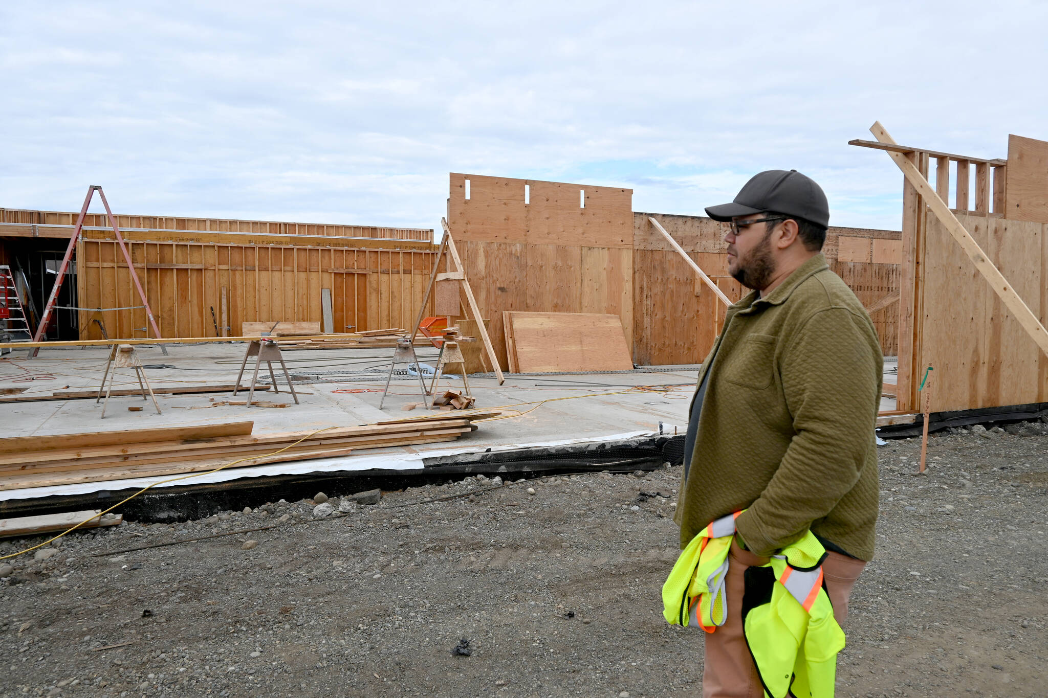 Noah Glaude, North Olympic Library System’s executive director, looks over recent construction at the site of the Sequim Library’s expansion. (Michael Dashiell/Olympic Peninsula News Group)