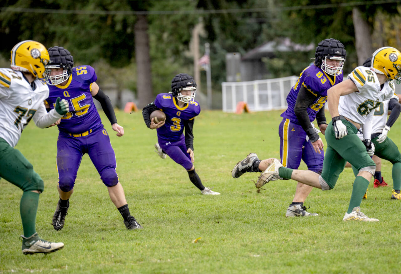 Quilcene's Robert Evans sees a hole opened by linemen Hunter Simmons (55) and Taylor Boling (83)  during a Saturday game in Quilcene against the Darrington Loggers. Quilcene won 48-8 to improve to 6-1 on the season. (Steve Mullensky/for Peninsula Daily News)