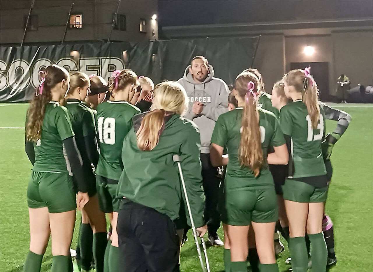 Port Angeles head girls soccer coach Daniel Horton talks with his team before beginning its rivalry match Tuesday night against Sequim at Wally Sigmar Field at Peninsula College. (Pierre LaBossiere/Peninsula Daily News)