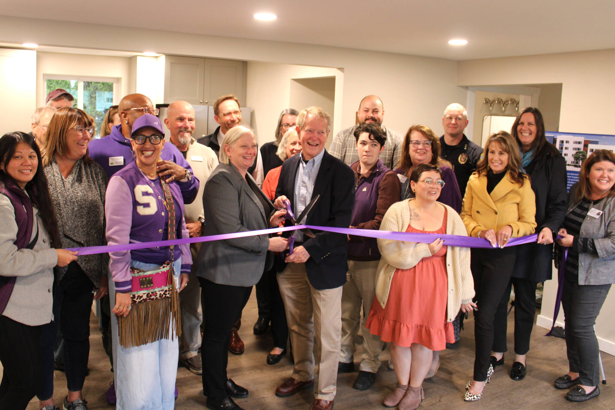 Wendy Sisk, CEO for Peninsula Behavioral Health, and Clallam County commissioner Randy Johnson cut a ribbon with the Sequim-Dungeness Valley Chamber of Commerce on Oct. 16 for PBH’s first transitional house in Sequim. County funds helped pay for the refurbished home for five adults. (Peninsula Behavioral Health)