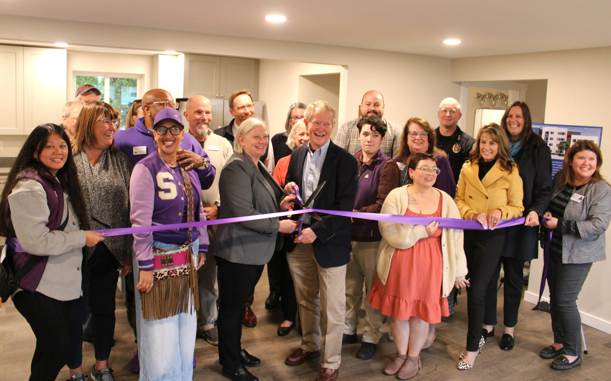 Wendy Sisk, CEO for Peninsula Behavioral Health, and Clallam County commissioner Randy Johnson cut a ribbon with the Sequim-Dungeness Valley Chamber of Commerce on Oct. 16 for PBH’s first transitional house in Sequim. County funds helped pay for the refurbished home for five adults. (Peninsula Behavioral Health)