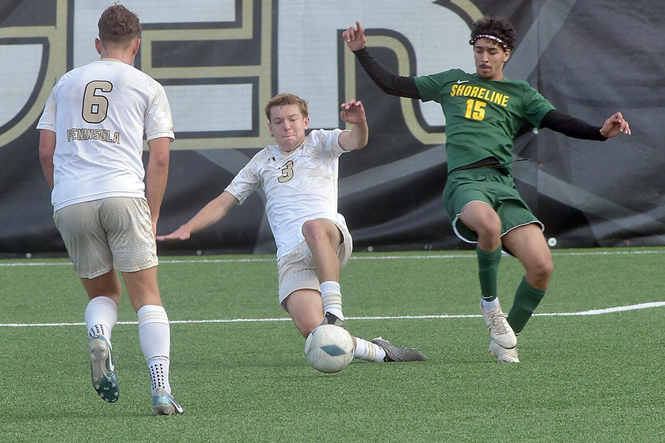 KEITH THORPE/PENINSULA DAILY NEWS
Peninsula's Caleb Rolo, center, makes a sliding tackle on Shoreline's Hamza Askour as teammate Konrad Muller looks on during Saturday's match in Port Angeles.