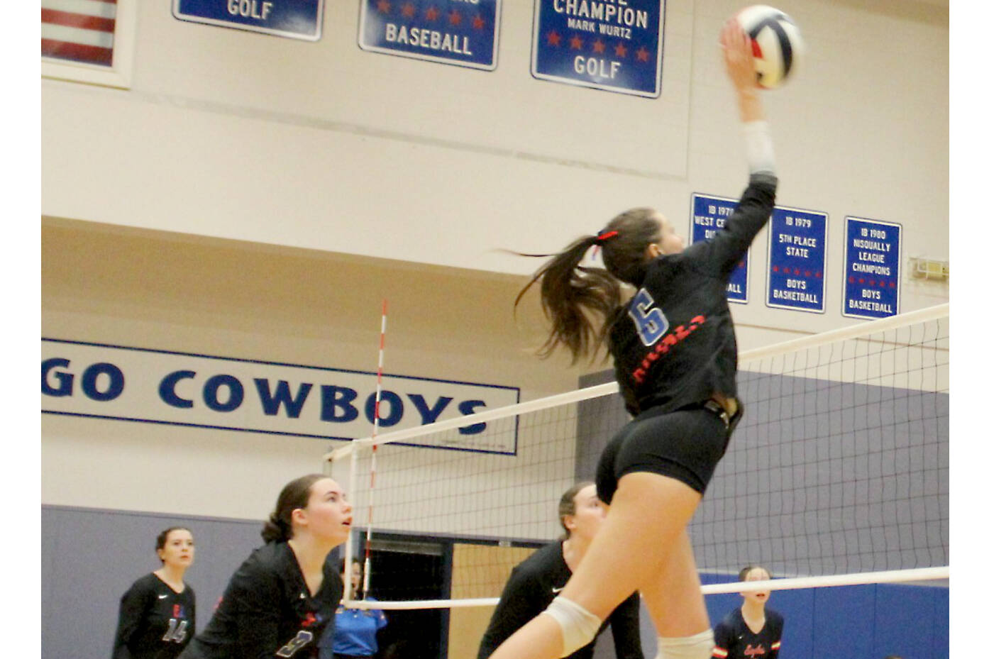 Senior Sophia Petta spikes the ball against Annie Wright on Monday night in Chimacum. It was Petta's final home match for the Rivals and she responded with 44 digs. (Courtesy of Carrie Beebe)