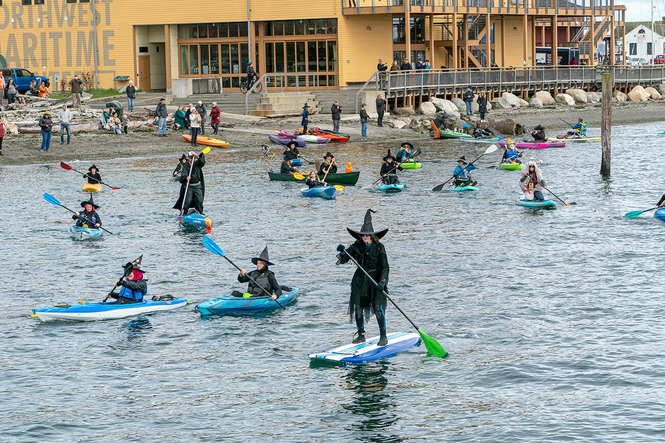 About two dozen witches set off on the second annual Witches Paddle from Northwest Maritime to the Pourhouse pub on Saturday, a distance of half a mile. (Steve Mullensky/for Peninsula Daily News)