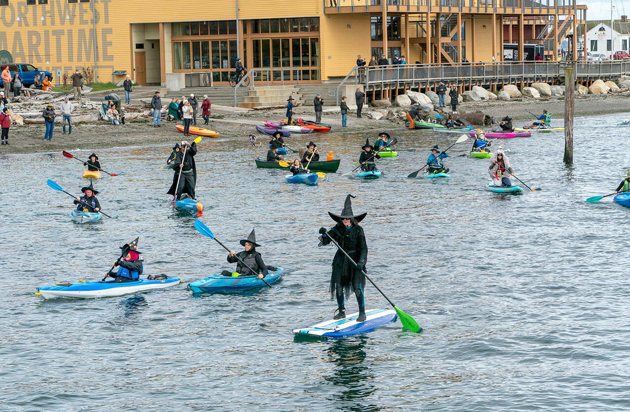 About two dozen witches set off on the second annual Witches Paddle from Northwest Maritime to the Pourhouse pub on Saturday, a distance of half a mile. (Steve Mullensky/for Peninsula Daily News)