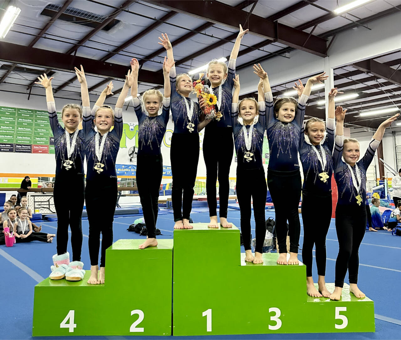 The Klahhane XCEL Bronze team celebrates its first-place finish at the Harvest Fest Gymnastics meet in Mukilteo this weekend. From left are Kinley Matthews, Penny Goodwin, Sasha Gmazel, Addie Brown, Lucy Monaghan, Aubrie Huisman, Nora Pecoraro, Adrie McGuire and Reagan Haguewood. (Klahhane Gymnastics)