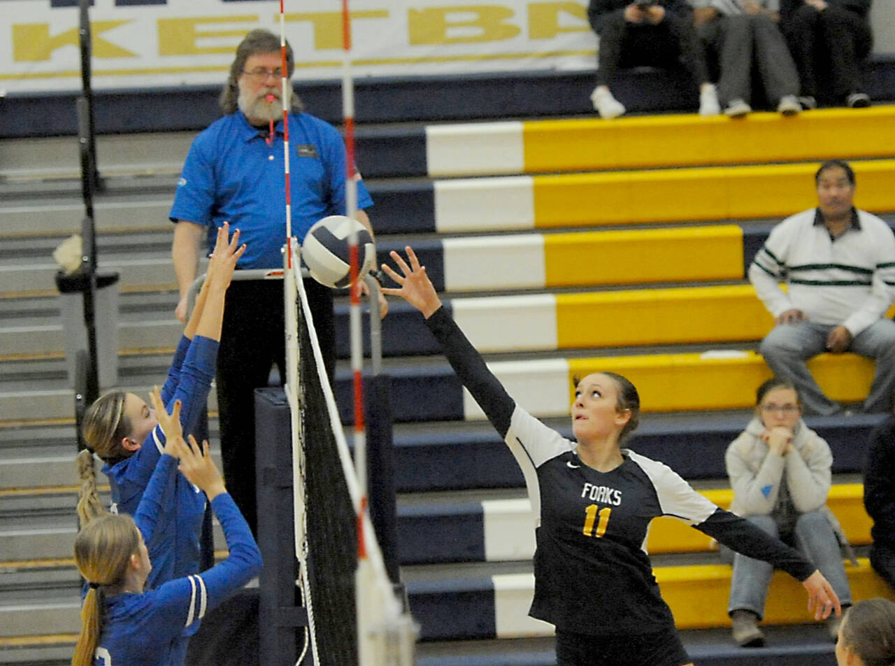 Avery Dilley tips the ball against Toutle Lake in this District 4 2B volleyball tournament held in Forks on Saturday. Forks won 3-1 to move on to the district semifinals against Mossyrock in Raymond on Wednesday. (Lonnie Archibald/for Peninsula Daily News)