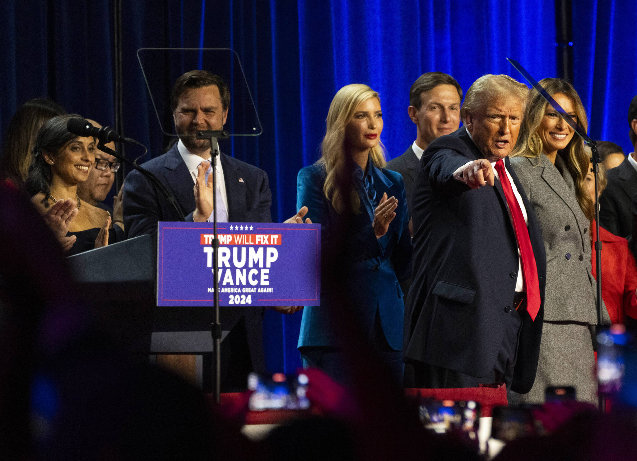 President-elect Donald Trump points to supporters in the audience at his election night gathering in West Palm Beach early Wednesday. Trump rode a promise to smash the American status quo to win the presidency for a second time on Wednesday, surviving a criminal conviction, indictments, an assassin’s bullet, accusations of authoritarianism and an unprecedented switch of his opponent to complete a remarkable return to power. (Hiroko Masuike/The New York Times)