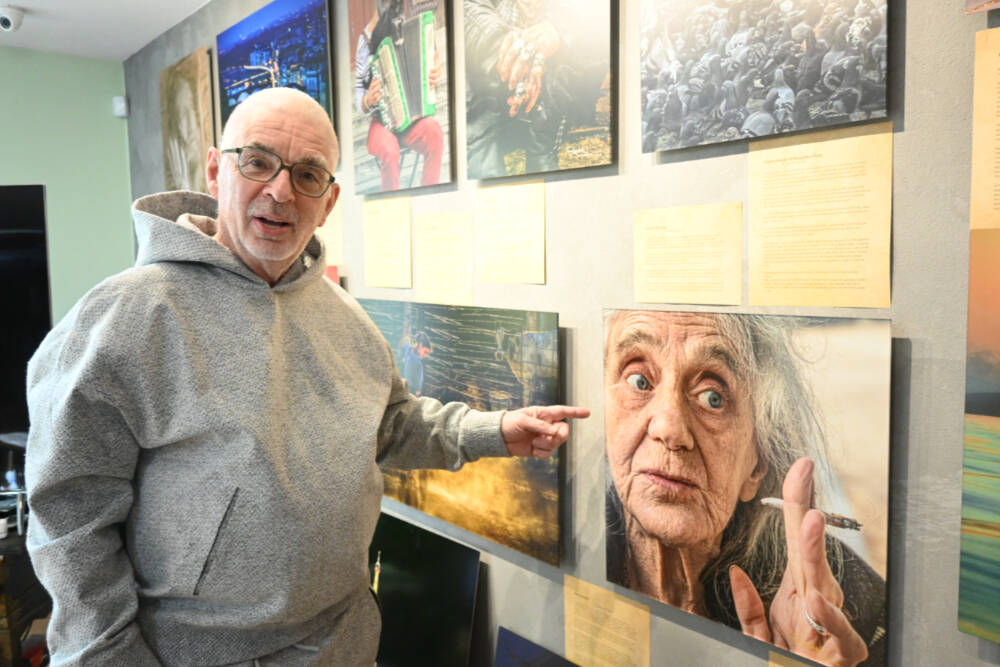 Sequim photographer Randy Tomaras points to a photo featured in his two-volume course “It Is NOT the Camera.” Tomaras’ home studio will be featured in the Strait from the Artists Studio Tour today and Sunday. (Michael Dashiell/Olympic Peninsula News Group)