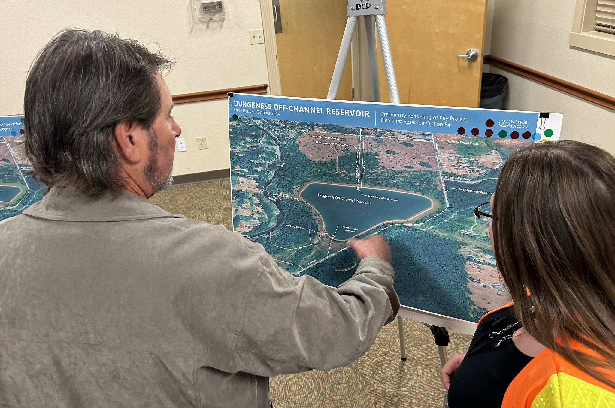 Matthew Nash/Olympic Peninsula News Group
Rich Krebsbach, manager of the Highland Irrigation District, asks questions of Rhiana Barkie, Clallam County public works project coordinator. The map is one of four new options for the Dungeness Off-Channel Reservoir project. Public input is being taken through the county’s website at https://www.clallamcountywa.gov/188/Dungeness-Off-Channel-Reservoir-Project.