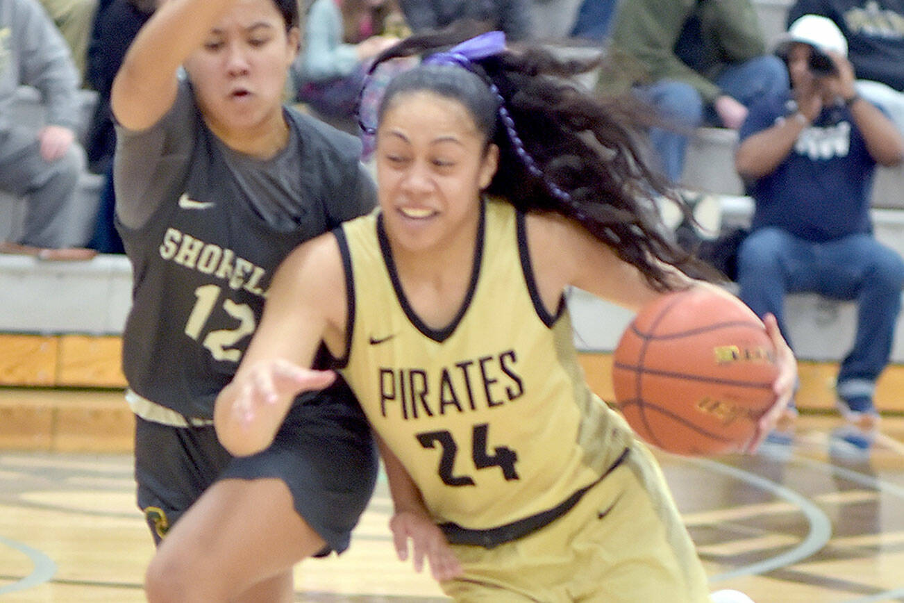 KEITH THORPE/PENINSULA DAILY NEWS Peninsula’s Shania Moananu, right, drives past Shoreline’s Mailana Mattos on Wednesday night in Port Angeles.