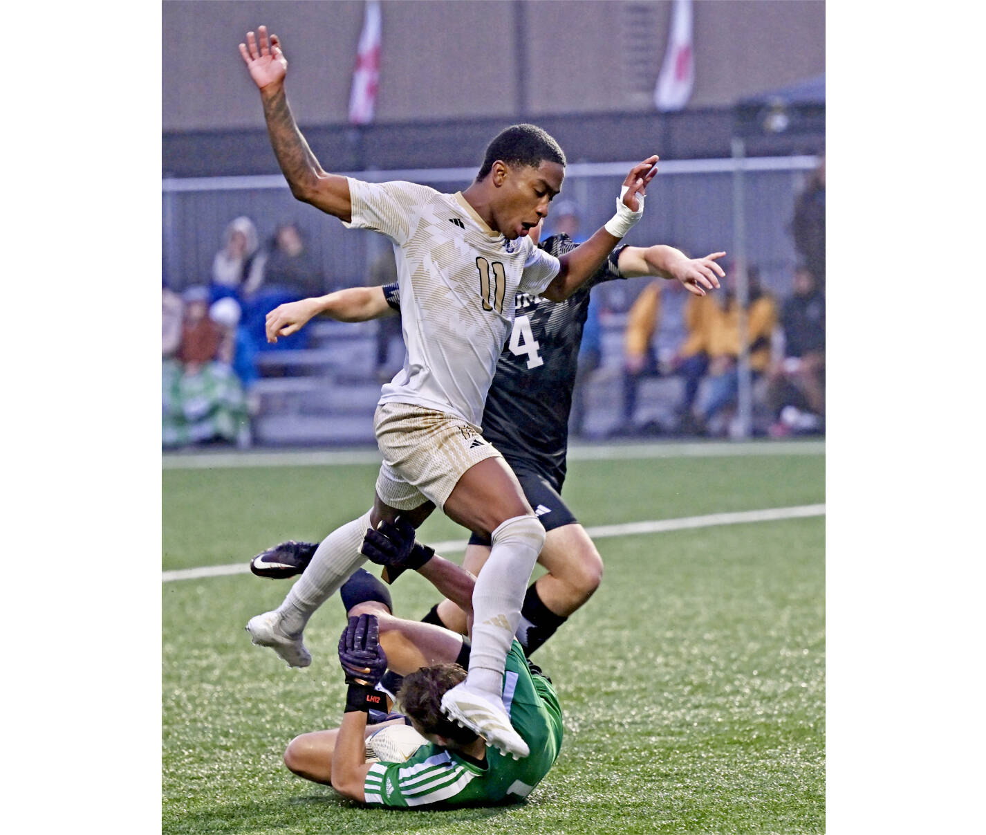 Peninsula College's Austin Collins battles Tacoma's Porter Herbig (No. 4) and goalkeeper Leif Hunter for a loose ball in the NWAC quarterfinals Saturday afternoon at Walley Sigmar Field. Collins scored two goals in a 3-0 win. (Jay Cline/Peninsula College)