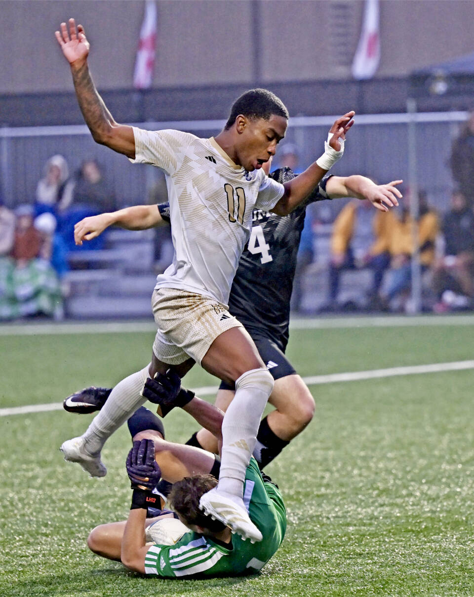 Peninsula College’s Austin Collins battles Tacoma’s Porter Herbig (No. 4) and goalkeeper Leif Hunter for a loose ball in the NWAC quarterfinals Saturday afternoon at Walley Sigmar Field. Collins scored two goals in a 3-0 win. (Jay Cline/Peninsula College)