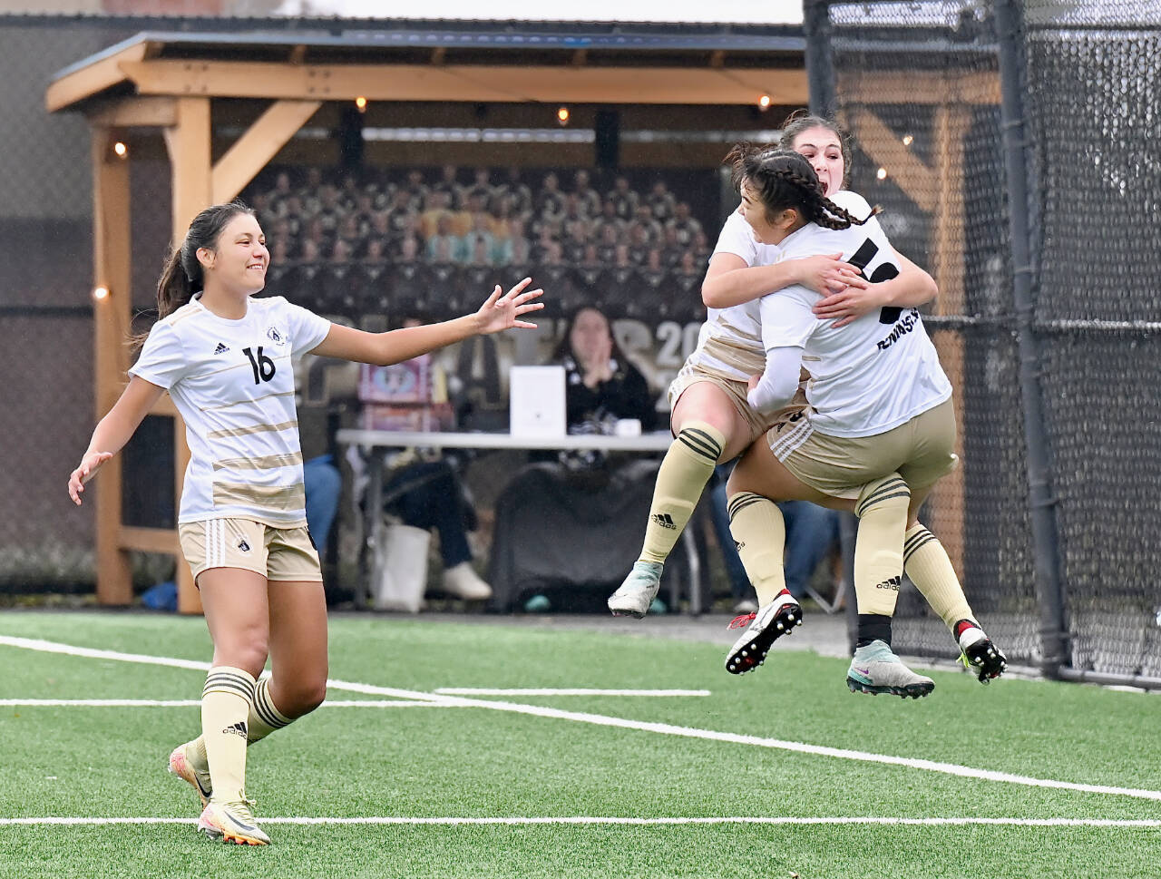 Peninsula College women's soccer players Desiree Dutra (No. 16), Ellise Maffeo and Risa Nishida (No. 5) all celebrate Maffeo's goal at the end of the first half in the NWAC quarterfinals Saturday at Wally Sigmar Field. Maffeo's goal was the only score of the game in a 1-0 Peninsula win. (Jay Cline/Peninsula College)