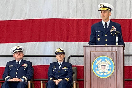 Rear Admiral Charles E. Fosse, right, U.S. Coast Guard District 13 commander, was the guest speaker at the U.S. Coast Guard Station Port Angeles’ annual Veterans Day celebration on Monday. Chaplain Mike VanProyen, left, and Kelly Higgins, the commanding officer at Coast Guard Air Station Port Angeles, also participated in the ceremony. (Paula Hunt/Peninsula Daily News)