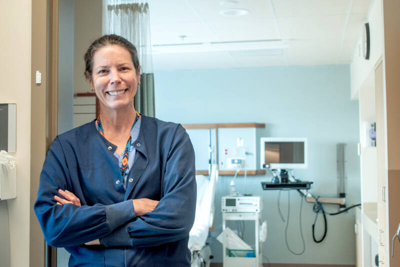 Tracy Ryan, a nurse at Jefferson Healthcare in Port Townsend, stands in front of one of the hospital’s maternity ward rooms. (Grace Deng/Washington State Standard)