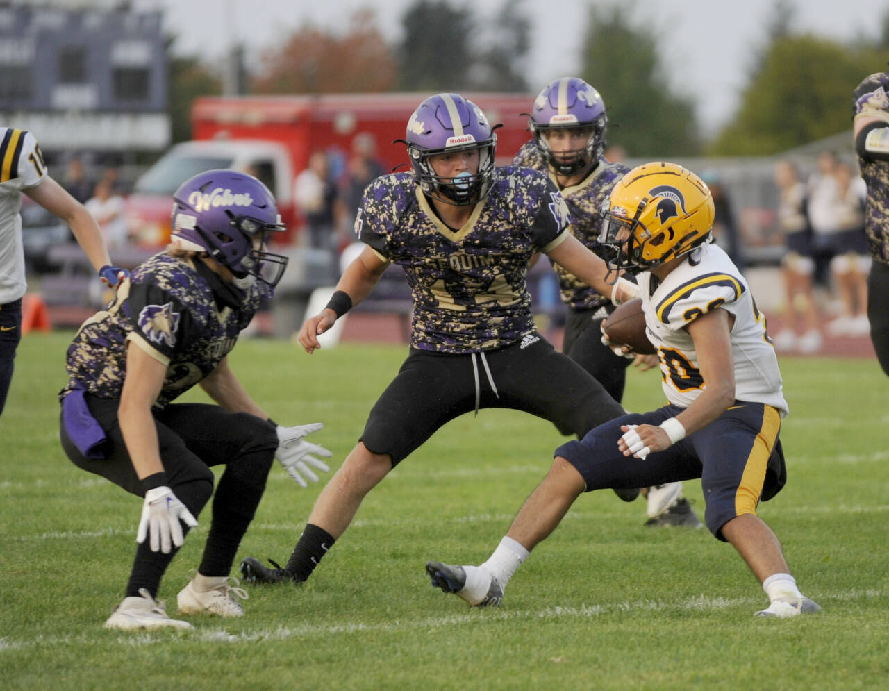 Sequim's Zeke Schmadeke, center, gets ready to tackle a Forks runner early this season in Sequim. Schmadeke made the all-Olympic League first team as a defensive back. (Michael Dashiell/Olympic Peninsula News Group).