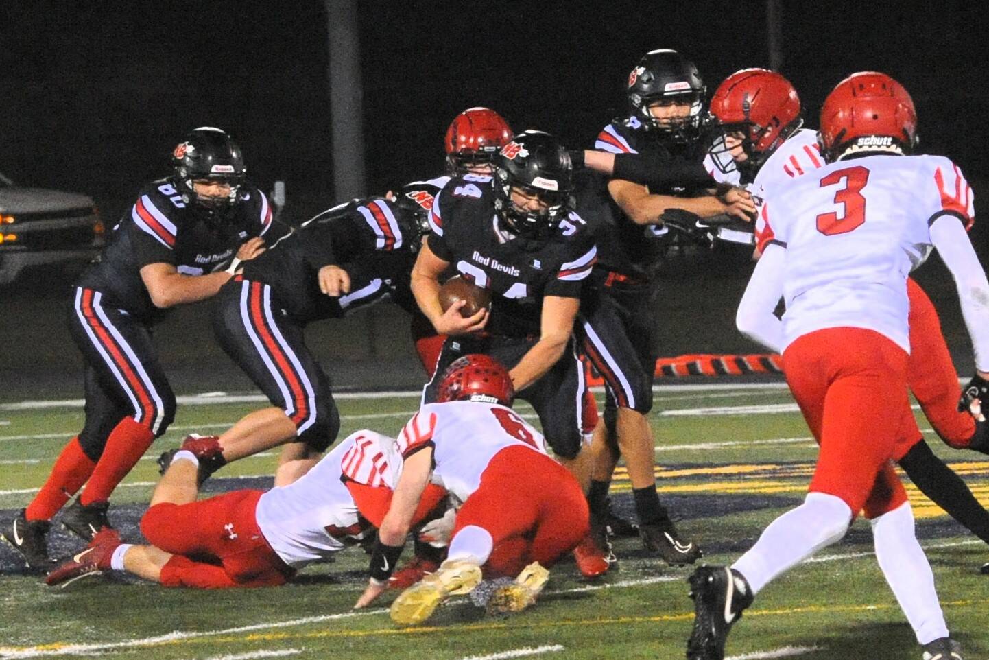 Neah Bay’s Tyler Swan (34) picks up yardage against Wahkiakum on the turf of Spartan Stadium in Forks Friday night in this state playoff contest. Lonnie Archibald/for Peninsula Daily News