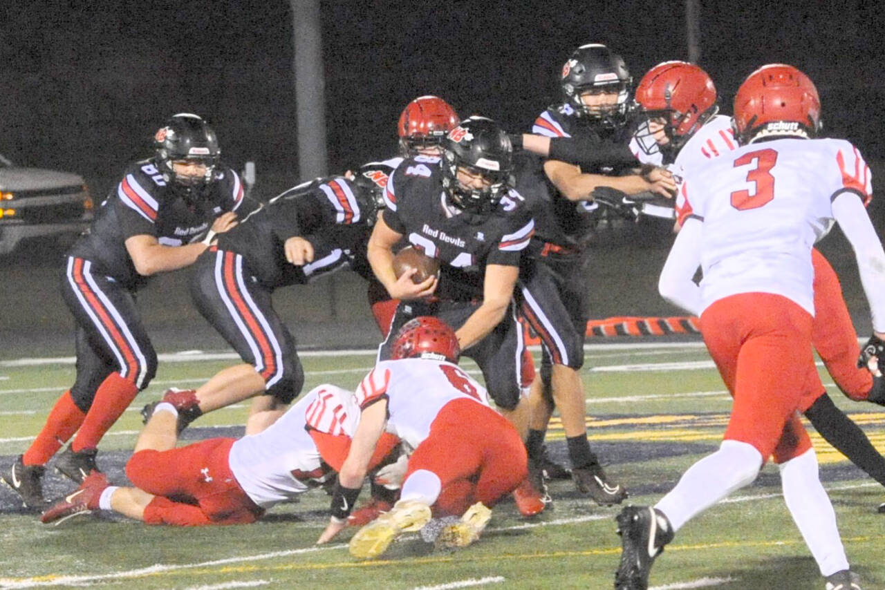 Neah Bay's Tyler Swan (34) picks up yardage against Wahkiakum on the turf of Spartan Stadium in Forks Friday night in this state playoff contest. Lonnie Archibald/for Peninsula Daily News