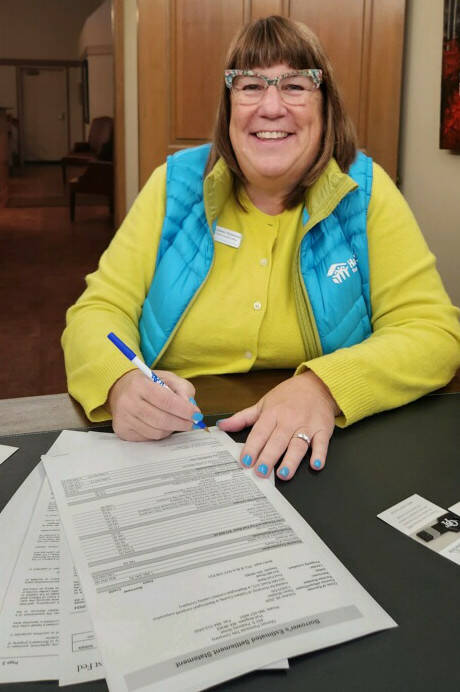 Colleen Robinson, CEO of Habitat for Humanity of Clallam County, signs off on purchasing 7.7 acres at 303 Mill Road in Carlsborg. Part of the $1.93 million purchase was covered by an $854,000 bequest from the late Frances J. Lyon. The property will be called Lyon’s Landing. (Habitat for Humanity of Clallam County)