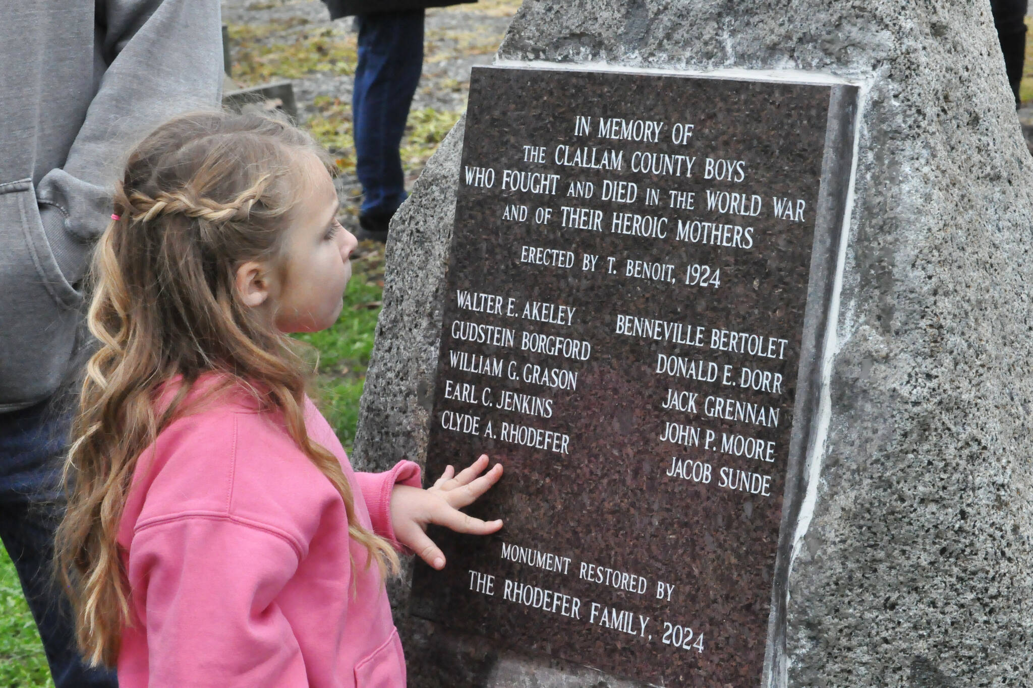 Clara (Rhodefer) Muma, 5, looks at a memorial honoring her great-great-great uncle Clyde Rhodefer of Sequim in front of Carlsborg Family Church on Nov. 9. The plaque was replaced and added the names of the men from Clallam County who died in World War I. (Matthew Nash/Olympic Peninsula News Group)