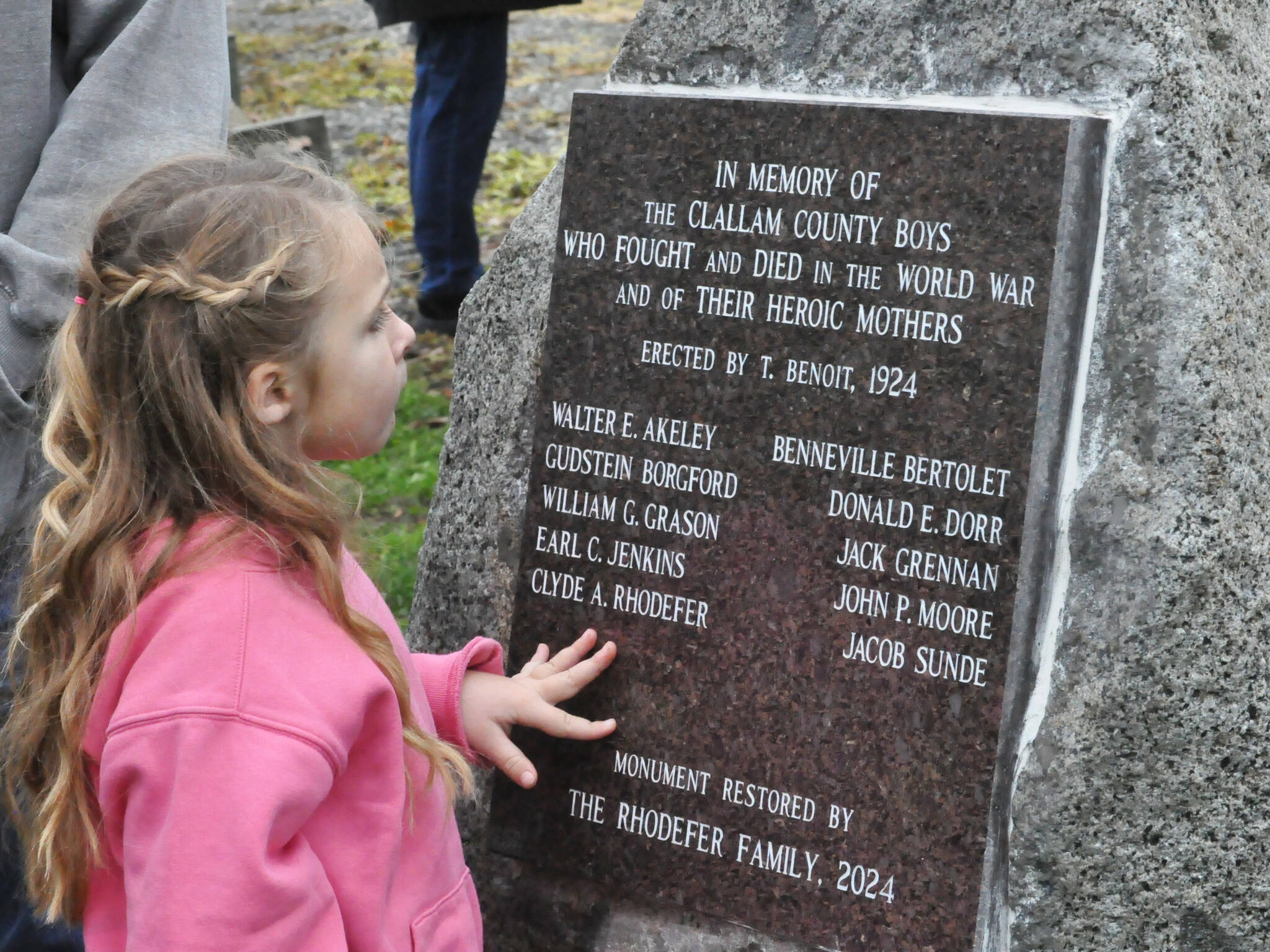 Clara (Rhodefer) Muma, 5, looks at a memorial honoring her great-great-great uncle Clyde Rhodefer of Sequim in front of Carlsborg Family Church on Nov. 9. The plaque was replaced and added the names of the men from Clallam County who died in World War I. (Matthew Nash/Olympic Peninsula News Group)