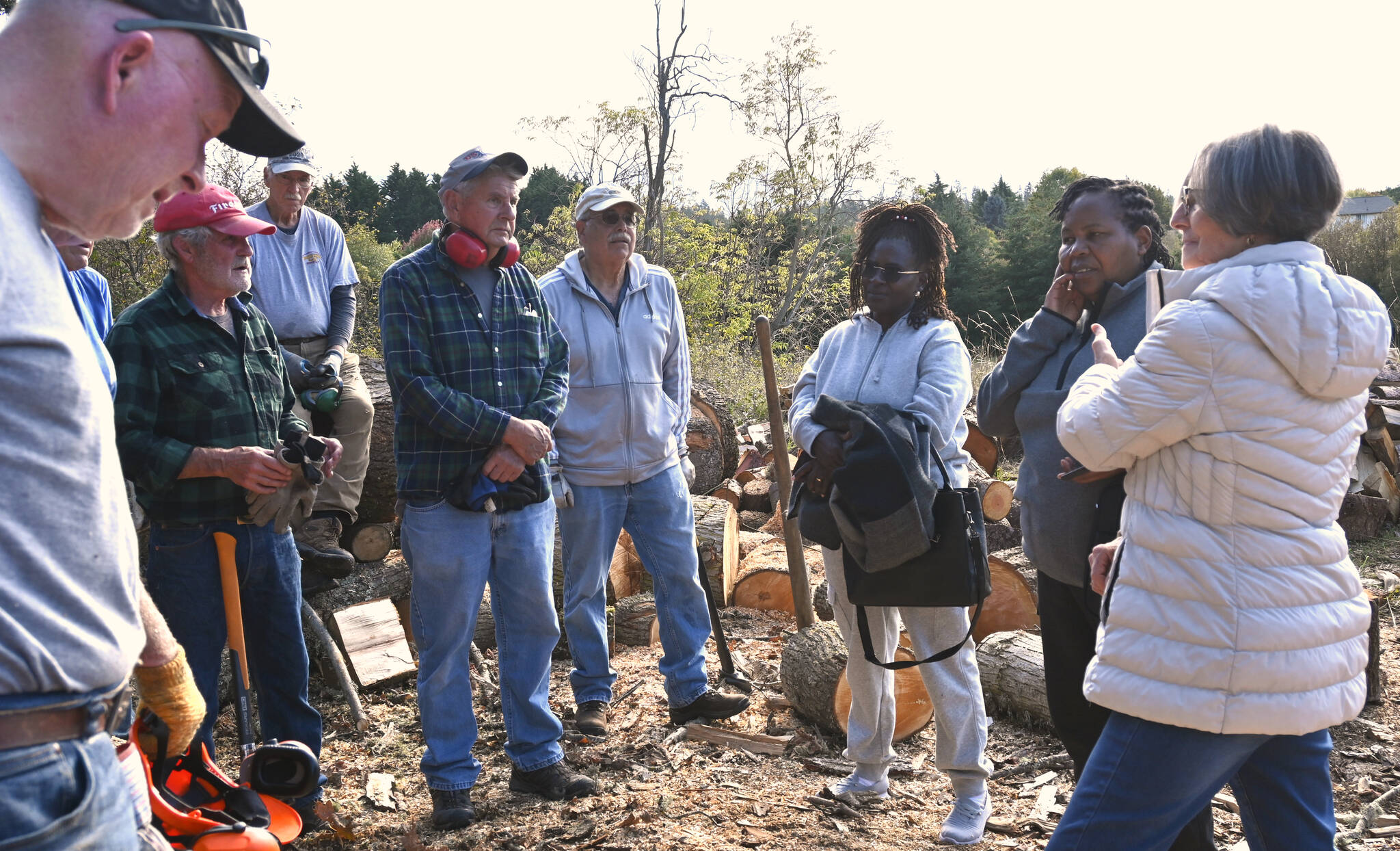 Agnes Kioko and Regina Mbaluku of Kenya and Bonita Piper, board president of Path From Poverty, right, meet with Sequim volunteers who cut and sell wood as a fundraiser. (Michael Dashiell/Olympic Peninsula News Group)