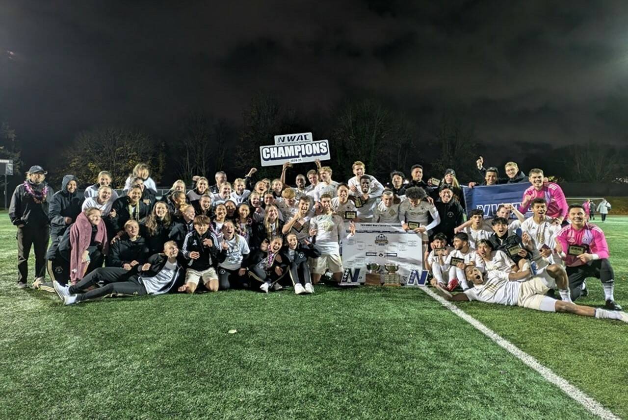 The Peninsula College men's and women's soccer teams celebrate their dual championships Sunday night Tukwila after the men beat Clark College 3-0 in their finals match. (Peninsula College)